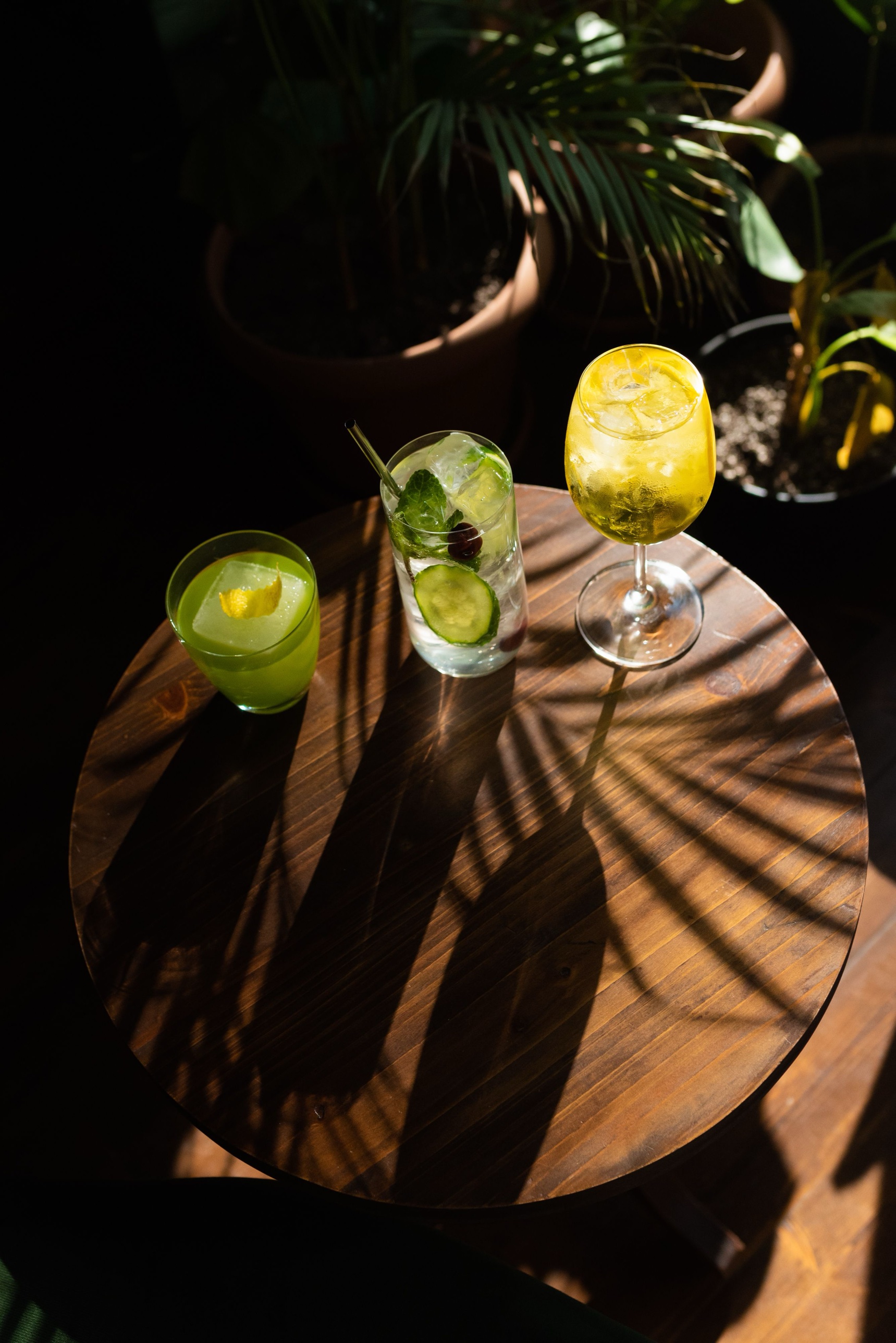 Three craft cocktails on a table
